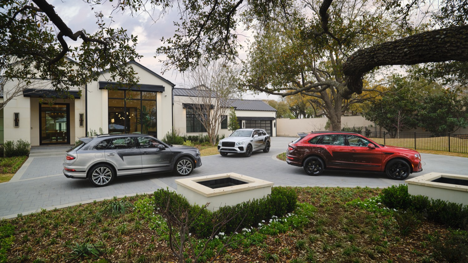 Three Bentley Bentaygas on the driveway of a private residence